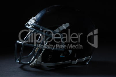 American football head gear on a black background