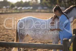 Female vet injecting horse at barn