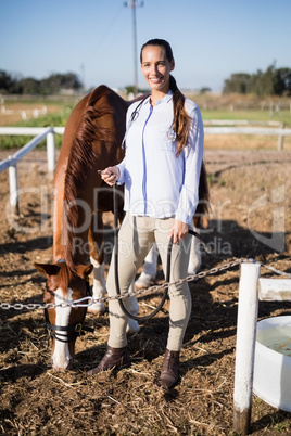 Full length portrait of vet standing by horse