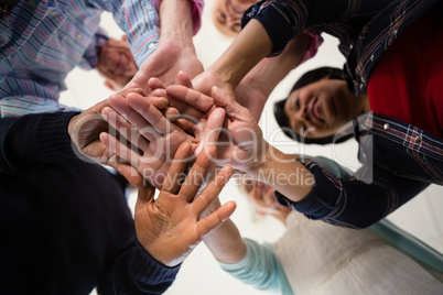 Directly below shot of senior friends stacking hands