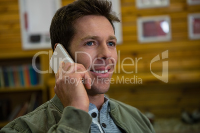 Man talking on smart phone at cafe