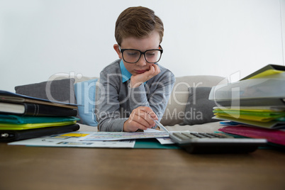 Businessman reading documents in office