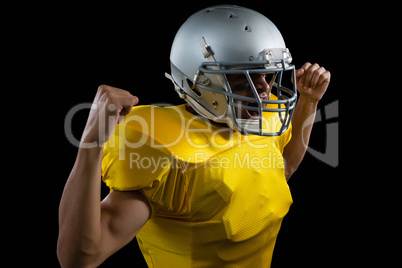 American football player flexing his muscles