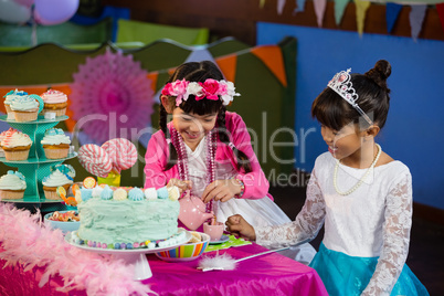 Friends interacting with each other during birthday party