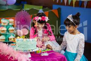 Friends interacting with each other during birthday party