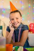 Girl talking on mobile phone during birthday party