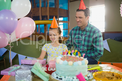 Father and daughter looking at gifts on table