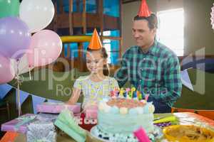 Father and daughter looking at gifts on table