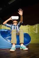 Boy sitting on bean bag and using virtual reality headset