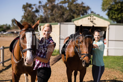 Portrait female friends with horses