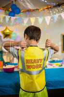 Boy gesturing to the text on protective workwear