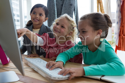 Designers planning over computer in creative office