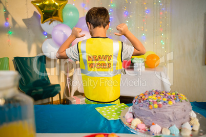 Boy gesturing to the text on protective workwear