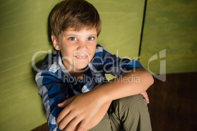 Smiling boy sitting at home