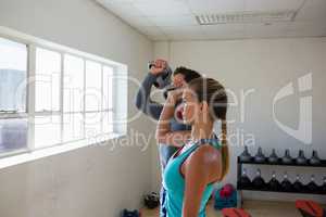 Athletes lifting kettlebells in fitness studio