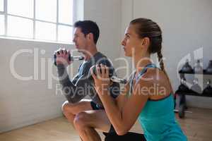 Athletes looking away while exercising with kettlebells