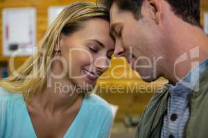 Close up of couple with eyes closed sitting at cafe