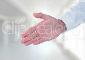 Business man stretching hand against white background