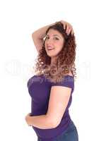Curvy woman standing in profile and smiling