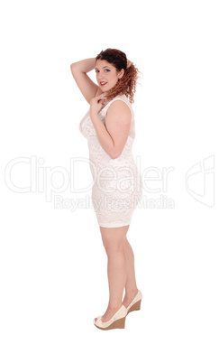 Woman standing in full length in beige dress