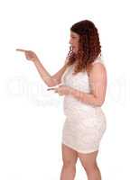 Woman in a short beige dress pointing finger
