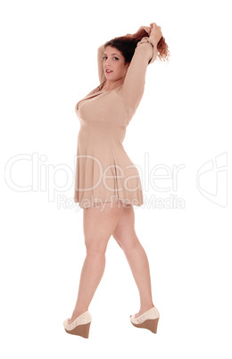 Beautiful woman in dress lifting her hands up