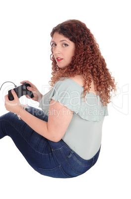 Woman sitting on floor playing her video game