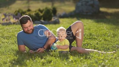 Smiling father and son enjoying leisure outdoors