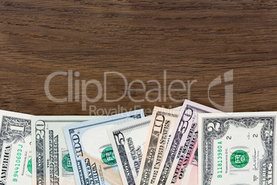 Dollar money banknotes on wooden background.