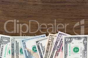Dollar money banknotes on wooden background.