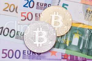 Golden and silver bitcoins on US dollars and euro. Electronic mo