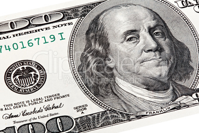 Stack shot of Benjamin Franklin portrait from a 100 bill.