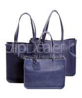 Three luxury women's handbags blue isolated on white