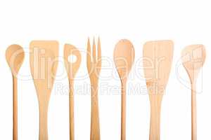 Set of new wooden kitchen utensils spoons isolated on white.