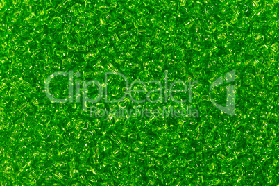 Many dark green seed beads background.