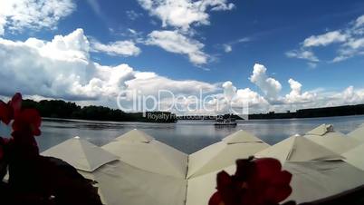 Timelapse of clouds and boats on the river