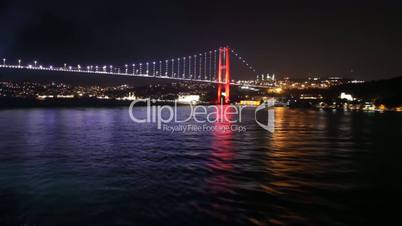 Sailing away from Istanbul's bridge at night