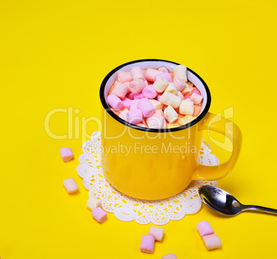 mug with a cocoa drink and pieces of a multicolored marshmallow
