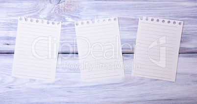 Three blank paper sheets in a line