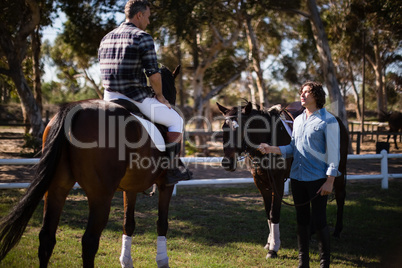 Two male friends interacting with each other in the ranch