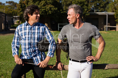 Two male friends interacting with each other in the ranch