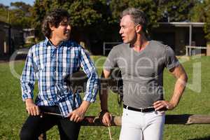 Two male friends interacting with each other in the ranch