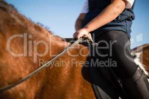 Boy riding a horse in the ranch
