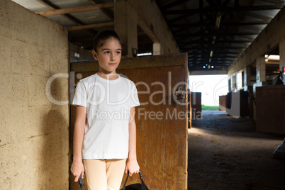 Girl standing in stable