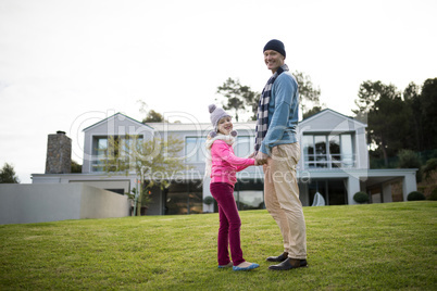 Smiling father and son standing in the garden