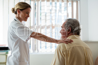 Doctor talking to senior man in nursing home
