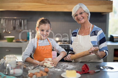 Granddaughter kneading dough