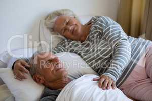Senior couple sleeping on bed in nursing home