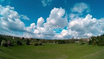 White Fluffy Clouds Moving Over The Field