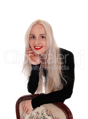 Woman bending over old armchair